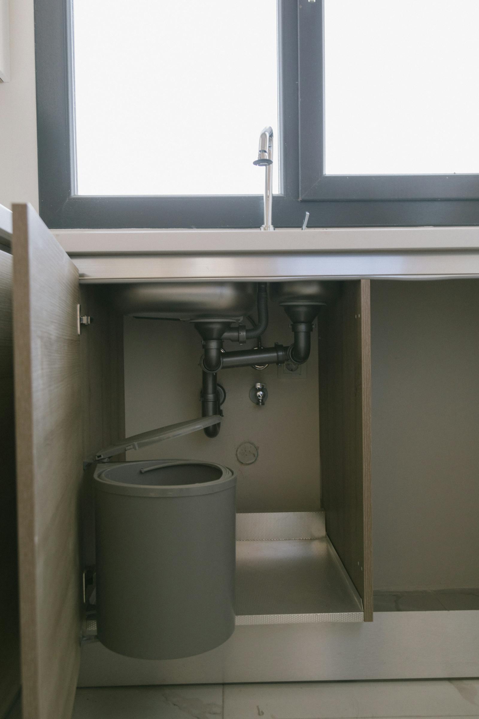 Drain cleaning under a sink in an Ajax home
